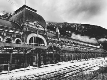 Railroad station against mountain during winter