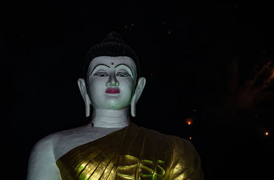 Close-up of statue against black background