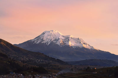 Scenic view of snowcapped mountains against sky during sunset