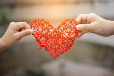 Close-up of hand holding red heart