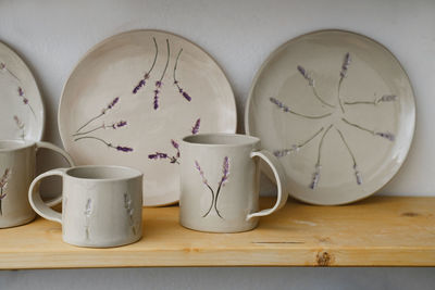 Ceramics with floral and natural patterns on the shelf of the shop. creative minimalistic handmade