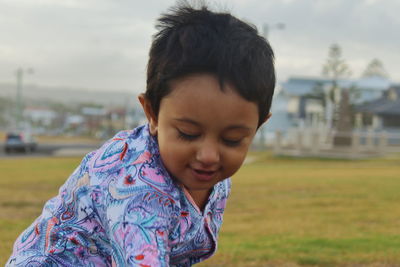Close-up of boy against sky