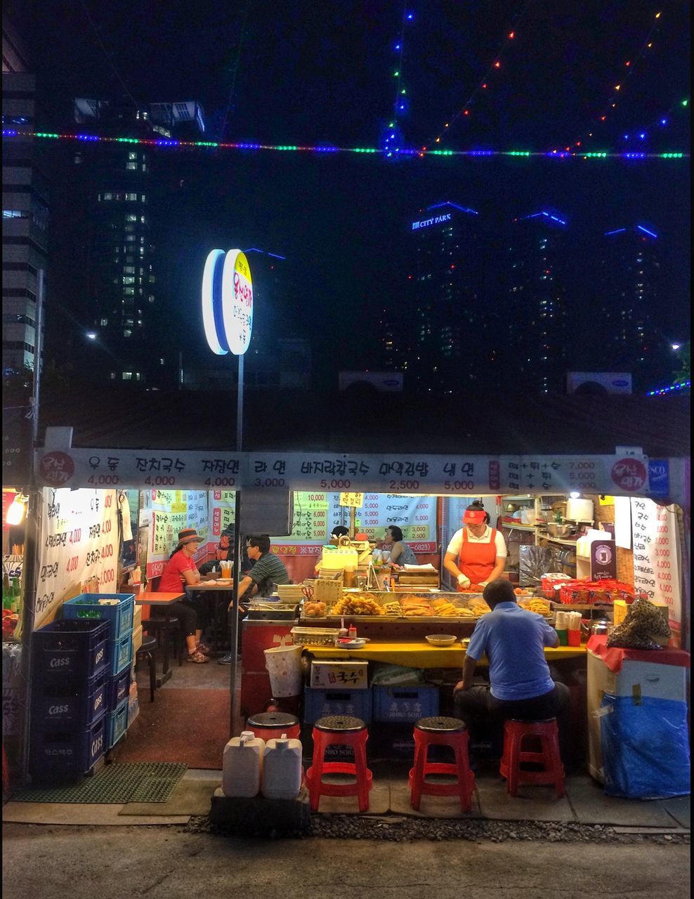 night, store, illuminated, architecture, men, building exterior, retail, built structure, city, shop, lifestyles, market, street, rear view, incidental people, person, city life, full length