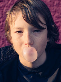 Close-up portrait of boy with bubble gum