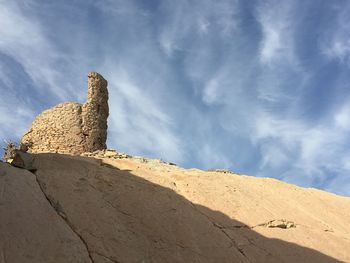 Low angle view of rock formations against sky