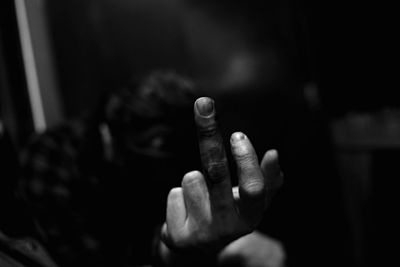 Close-up of cropped hand holding plant