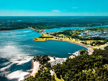 High angle view of bay against blue sky
