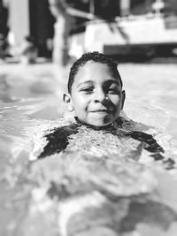 Portrait of smiling boy swimming in pool