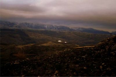 Scenic view of mountains against cloudy sky