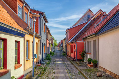 Houses amidst buildings against sky