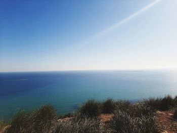 Scenic view of sea against clear blue sky