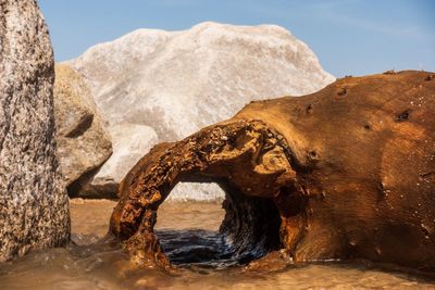 Rock formation in sea against sky