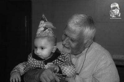 Close-up of father holding baby hand