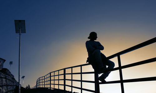 Low angle view of silhouette man against sky during sunset