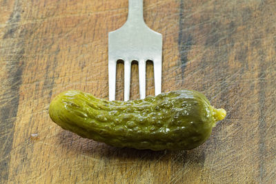 Close-up of vegetable on fork at table