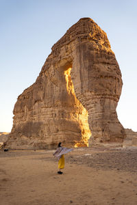 Unrecognizable woman in casual clothes enjoying sightseeing in the edge of the world in saudi arabia