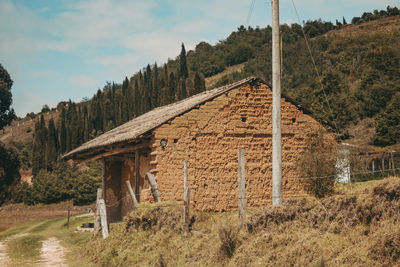 Panoramic shot of old building on field against sky