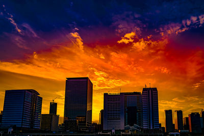 Skyscrapers against sky during sunset