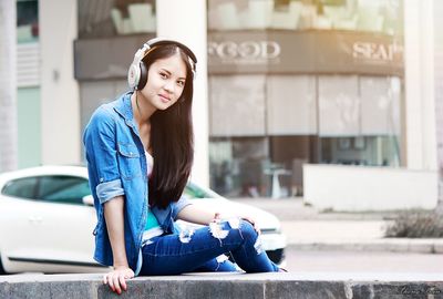 Young woman sitting on street