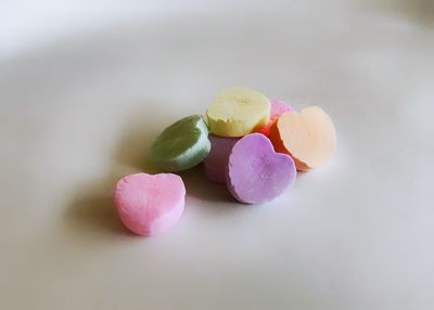 Heart shape candies over white background