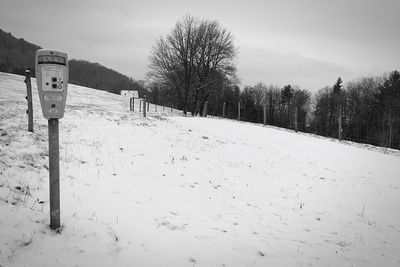 Snow covered field against sky