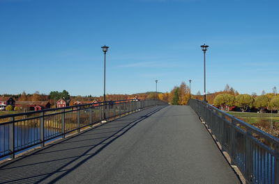 View of bridge over canal against blue sky