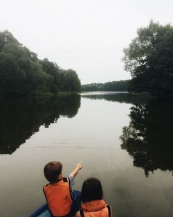 Rear view of people in lake