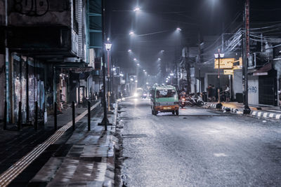 Illuminated city street at night