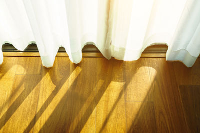 High angle view of curtain on hardwood floor