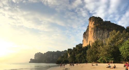 Group of people on beach against sky