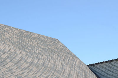 Low angle view of building against clear blue sky