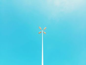 Low angle view of street lamp against clear blue sky