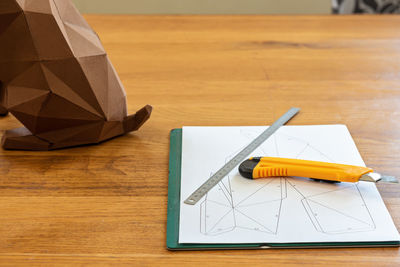 Paper, linear and knife on the table for diy