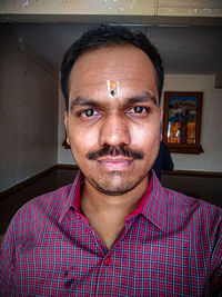 Portrait of man with mustache at home