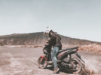 Man riding motorcycle on road