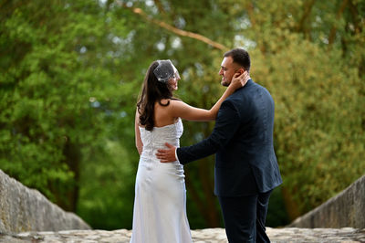 Rear view of couple standing in park