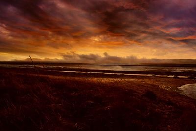 Scenic view of landscape against cloudy sky