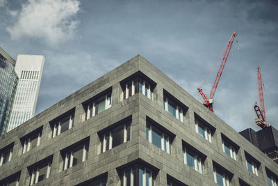 Low angle view of building against cloudy sky