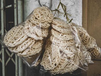 Close-up of rope tied on table against wall