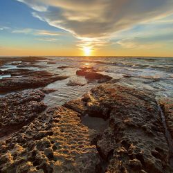 Scenic view of sea against sky during sunset