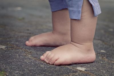 Baby feet on road without sleeper