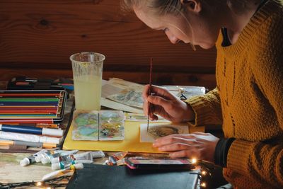 Close-up of woman painting watercolor