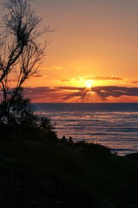 Scenic view of sea against orange sky