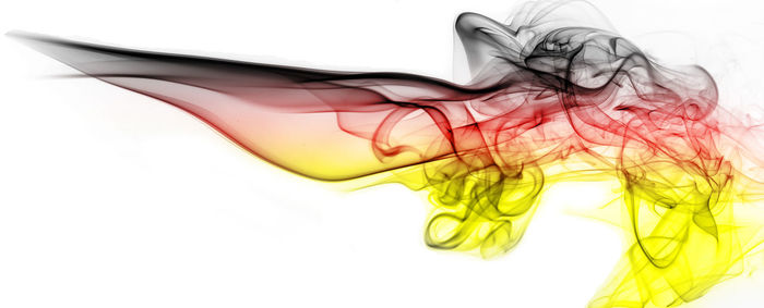 Close-up of colorful smoke against white background