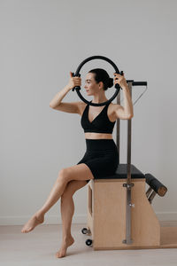 Portrait of young woman exercising in gym