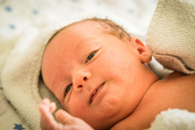 Close-up of cute baby boy sleeping on bed at home