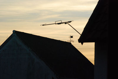 Silhouettes of house roofs with a weather vane. bredelem, germany.