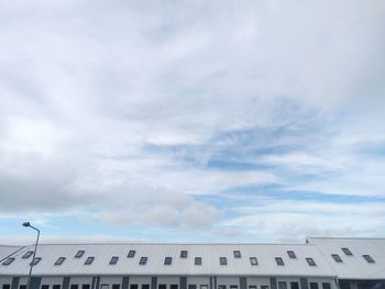 Low angle view of building against cloudy sky