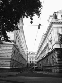 Street amidst buildings against clear sky