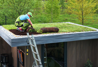 Rear view of man working on field